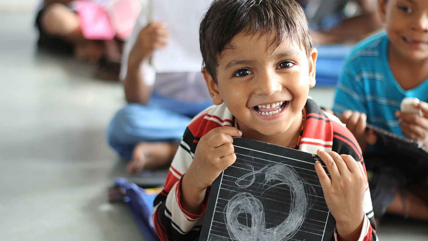 Child holding chalkboard