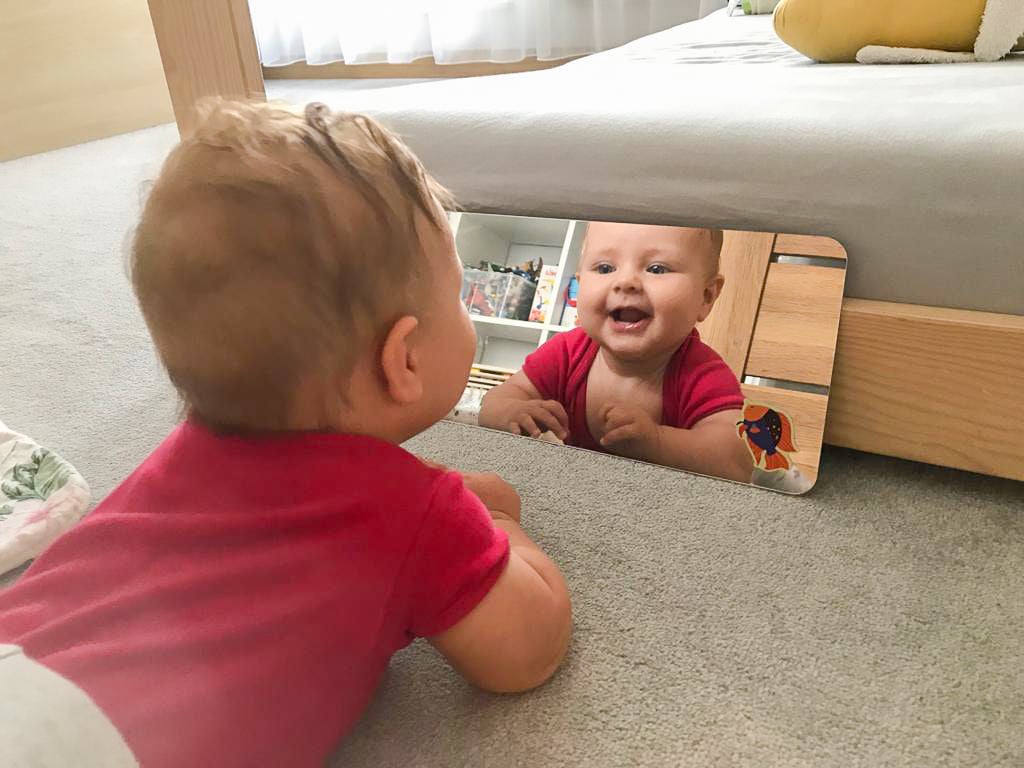 Child looking in a mirror